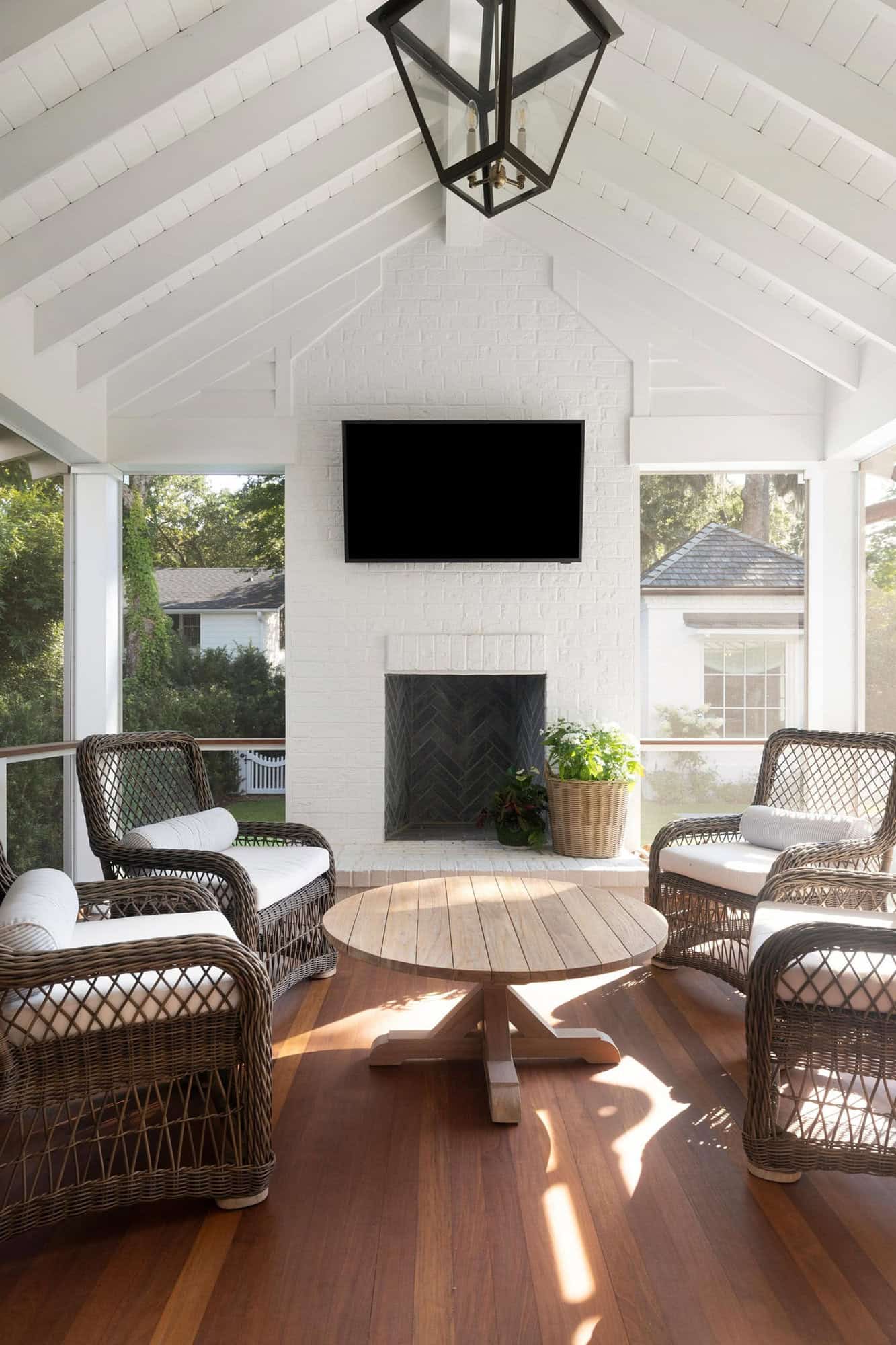 transitional-style-screen-porch-with-a-fireplace