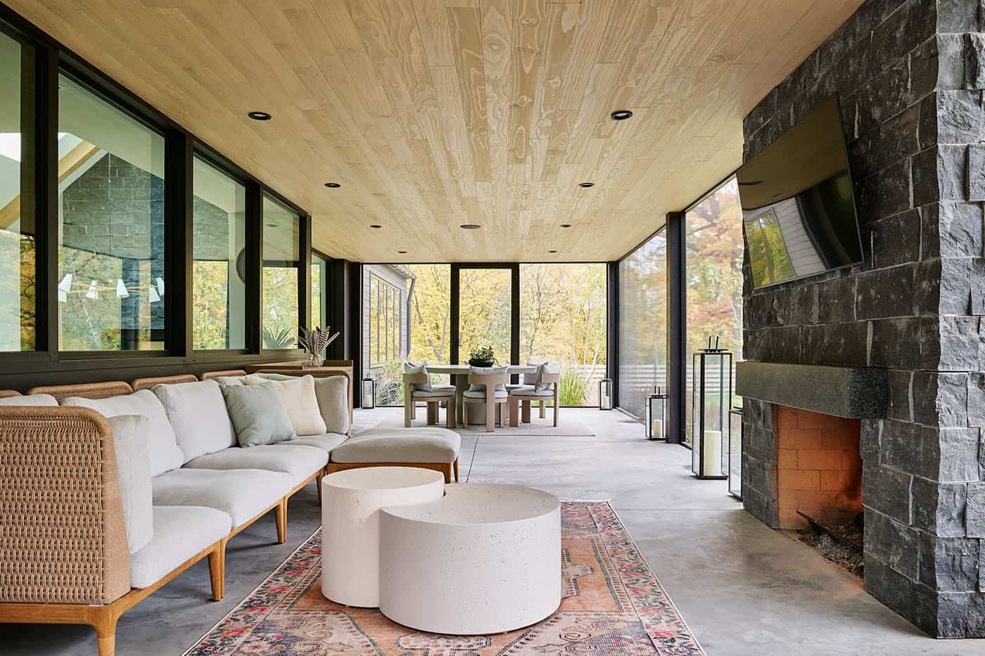 modern-screened-porch-with-outdoor-furniture-and-a-fireplace