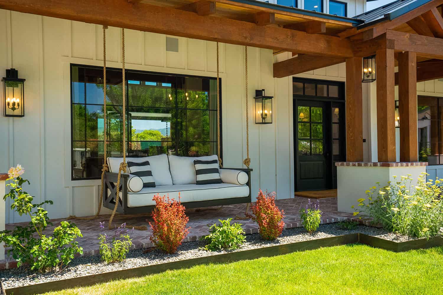 ranch-house-exterior-with-a-covered-front-porch-and-hanging-chair