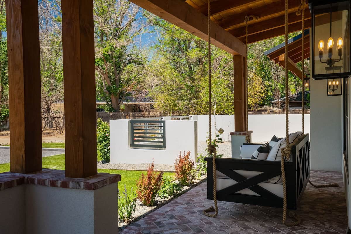 ranch-house-exterior-with-a-covered-front-porch-and-hanging-chair