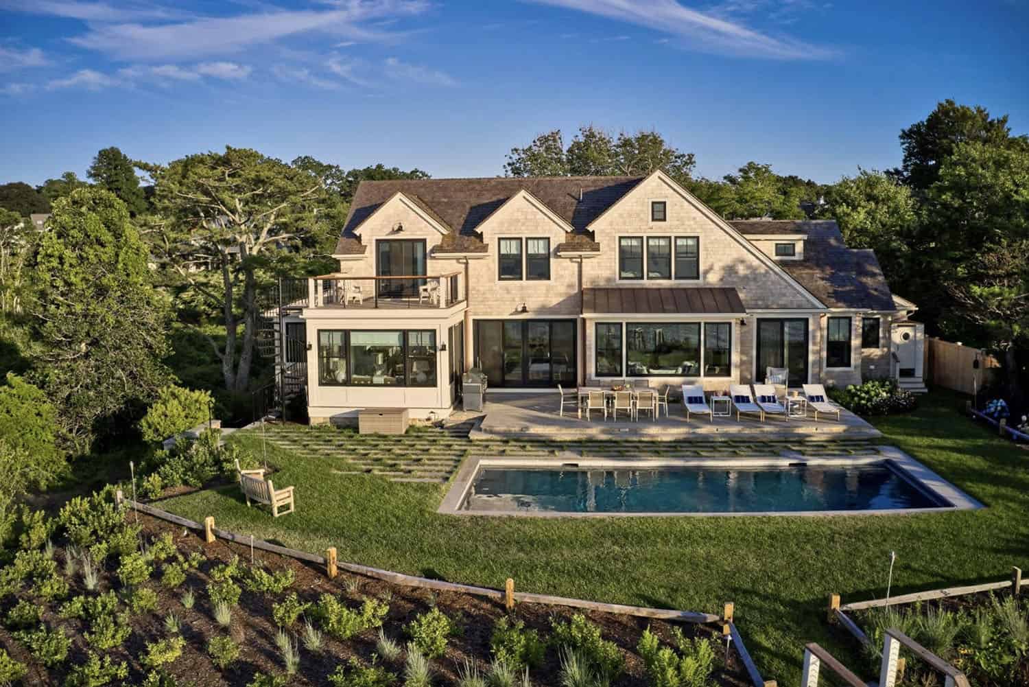 shingle-style-waterfront-house-exterior-with-a-pool