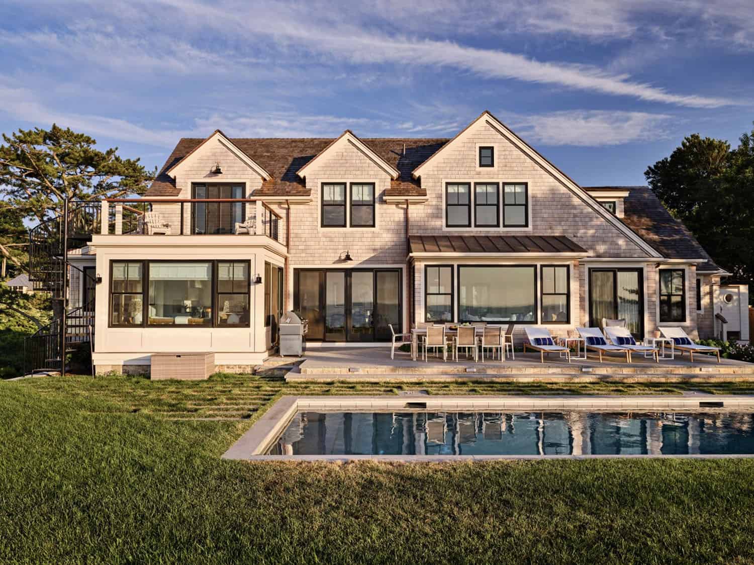 shingle-style-waterfront-house-exterior-with-a-pool