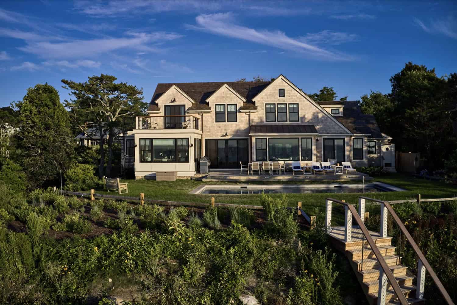 shingle-style-waterfront-house-exterior-backyard-view