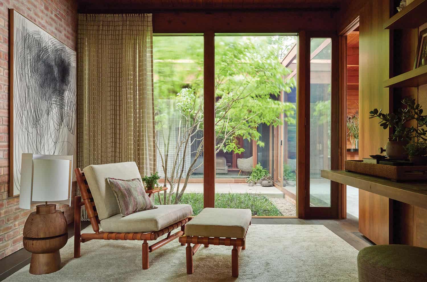 midcentury modern bedroom sitting area with sliding glass doors looking into a courtyard