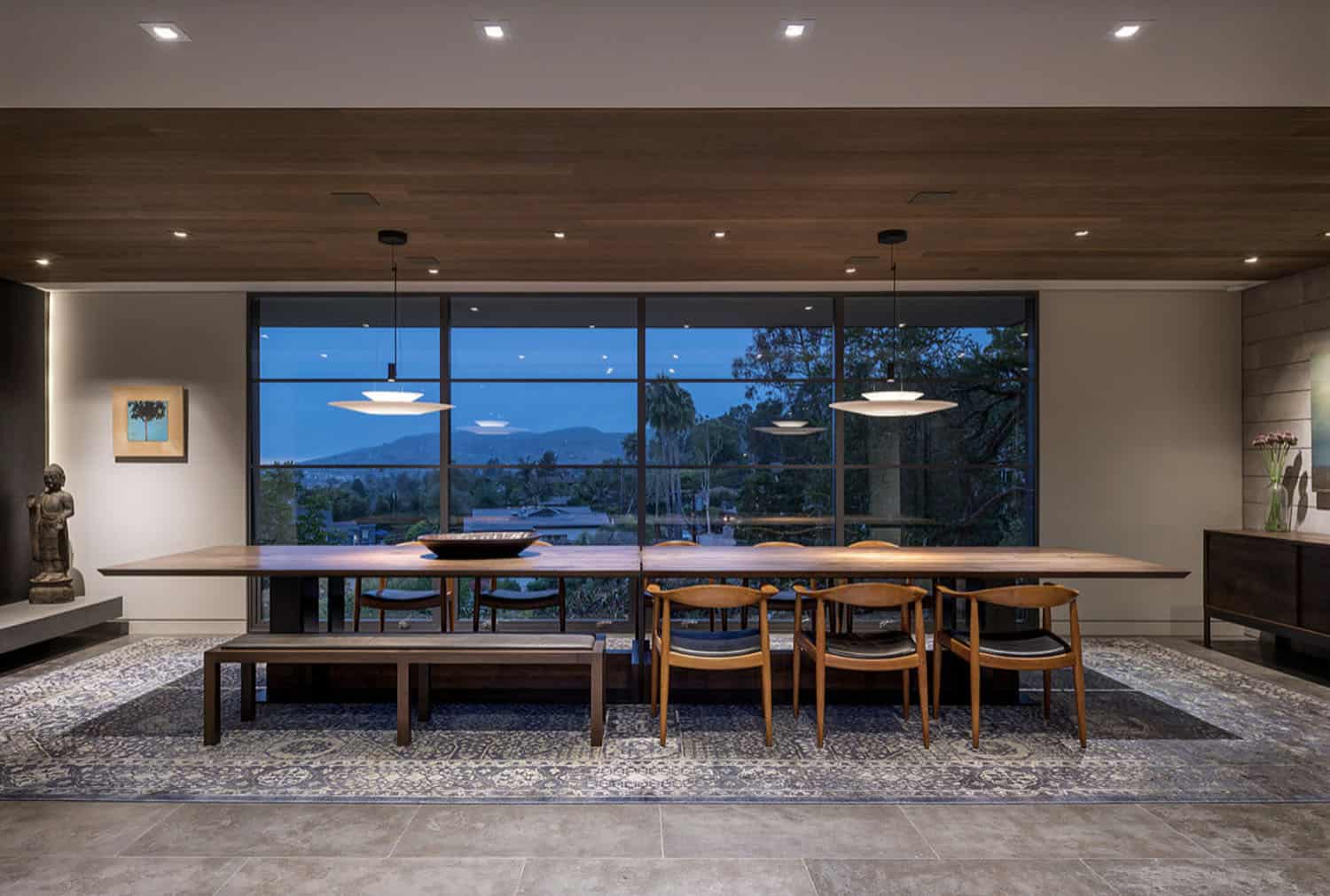 midcentury modern dining room at dusk with a large window