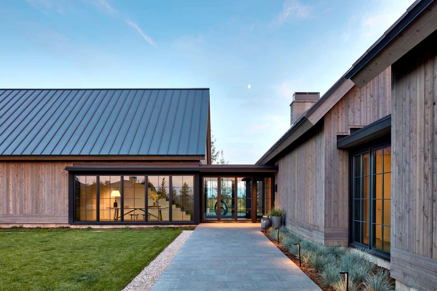 modern mountain home exterior at dusk