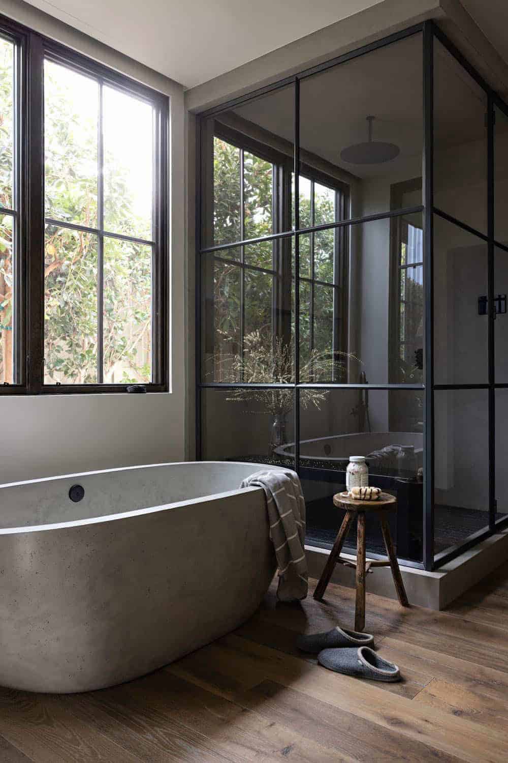 moody-modern-bathroom-with-a-soaking-tub-and-glass-shower