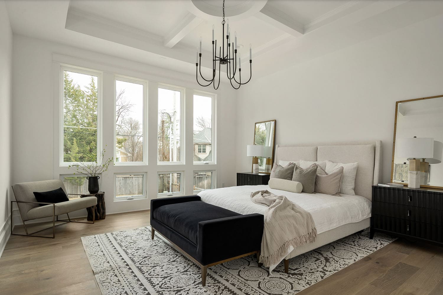 transitional style bedroom with a chandelier