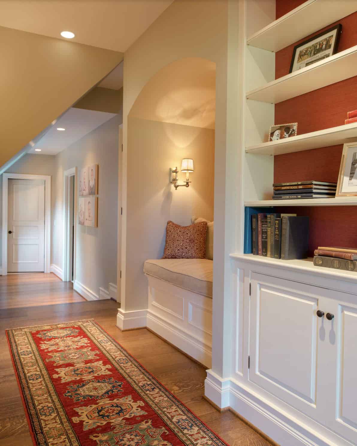 traditional hallway and landing with built-in cabinet and reading nook