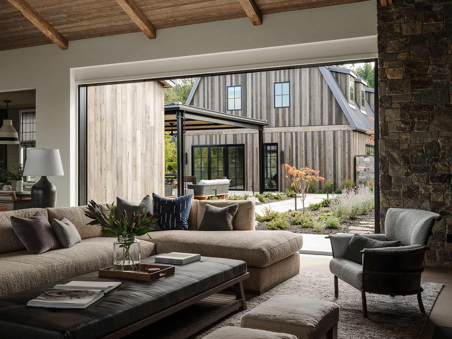 transitional style living room with walls of disappearing glass