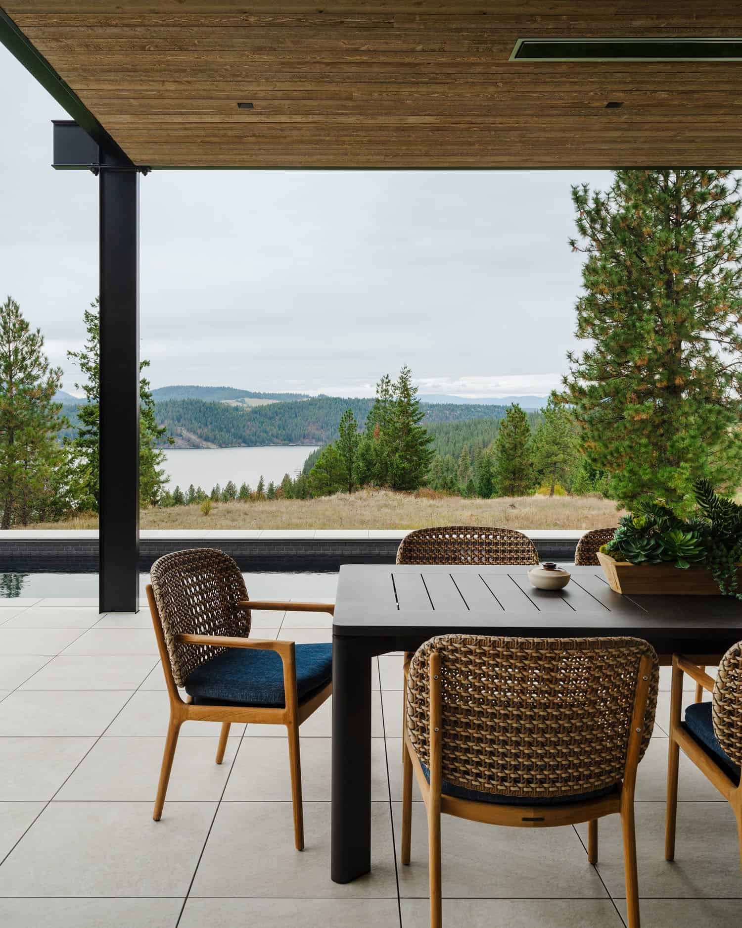 rustic modern home exterior with a pergola and alfresco dining