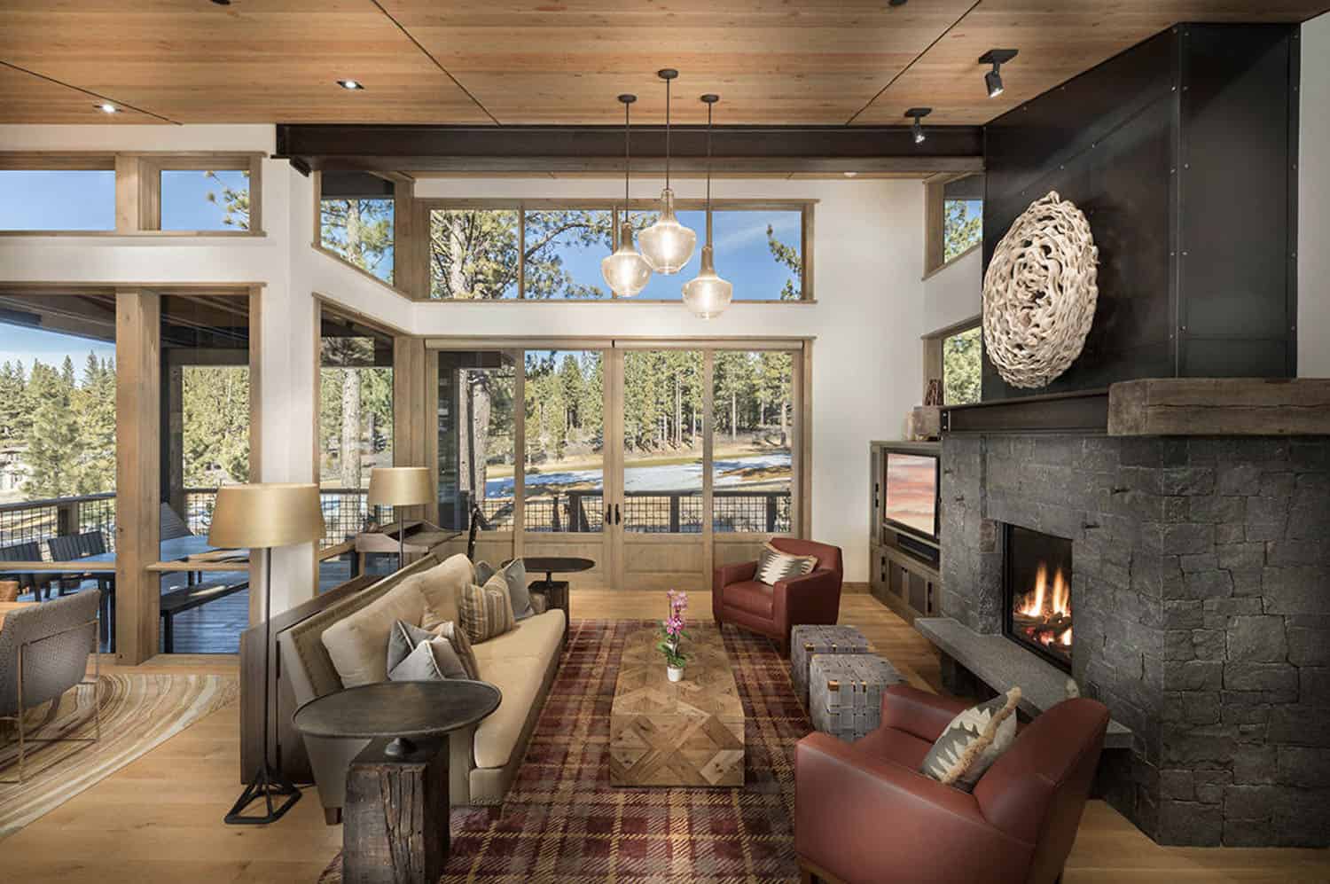 rustic modern living room with a fireplace and large windows