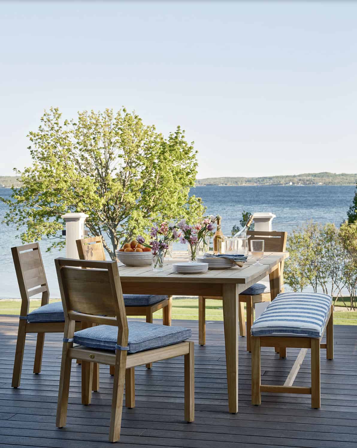 beach style deck with alfresco dining and a lake view