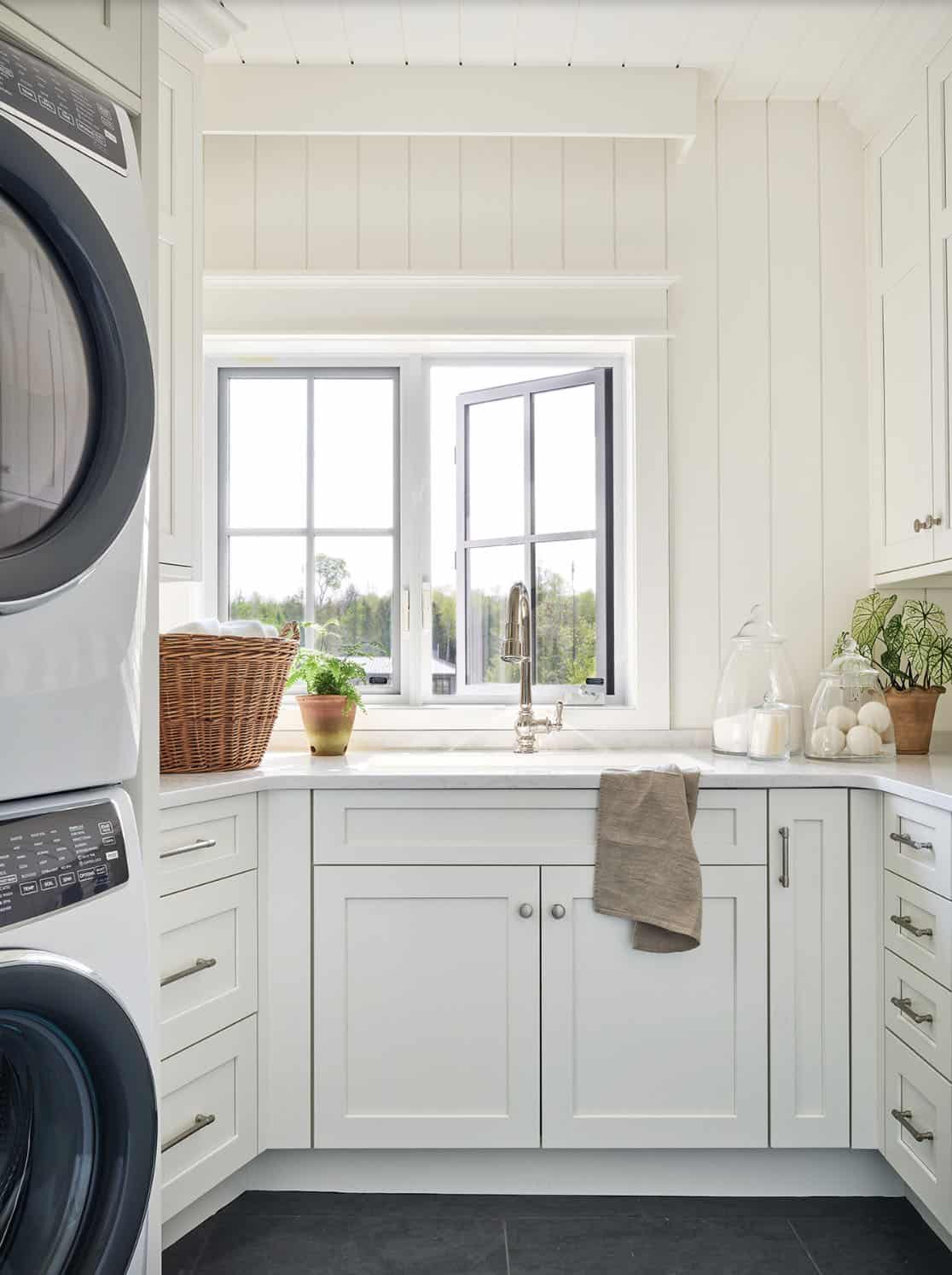 beach style laundry room with a stacked washer and dryer