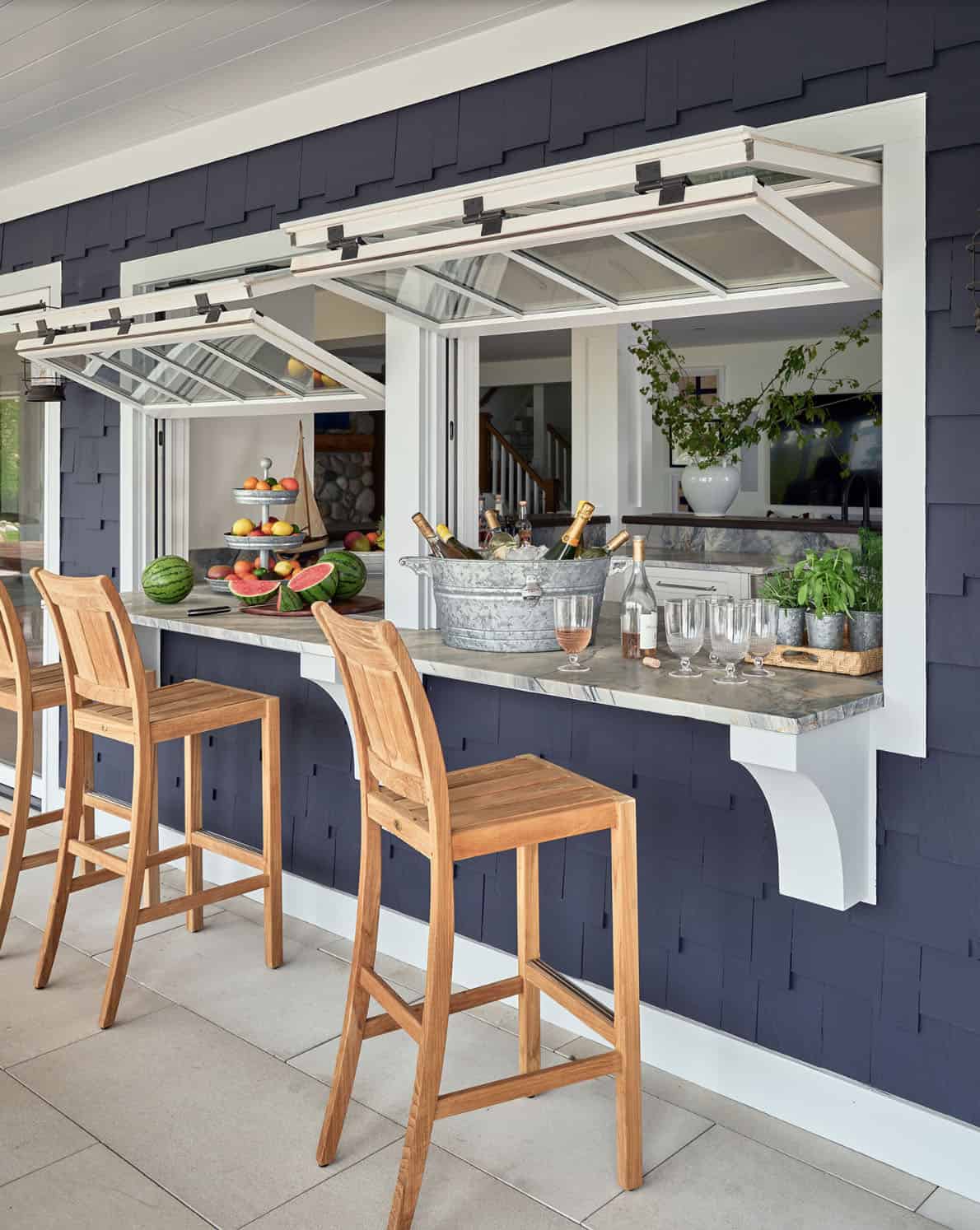 nautical style outdoor patio bar with a pass-through window to the indoors