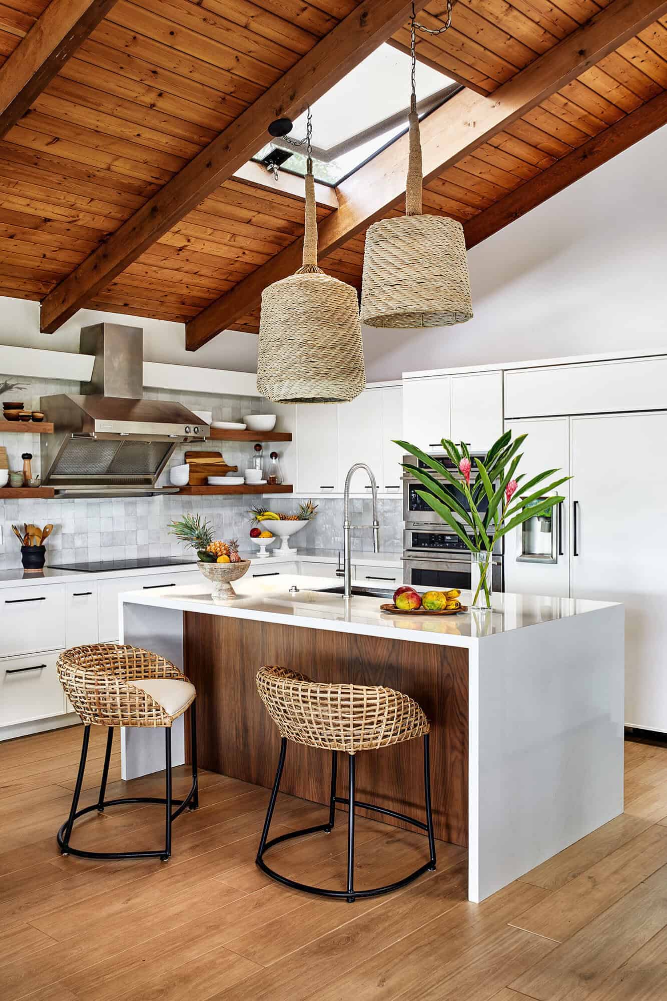 white and wood kitchen with a skylight and large wicker pendant lights