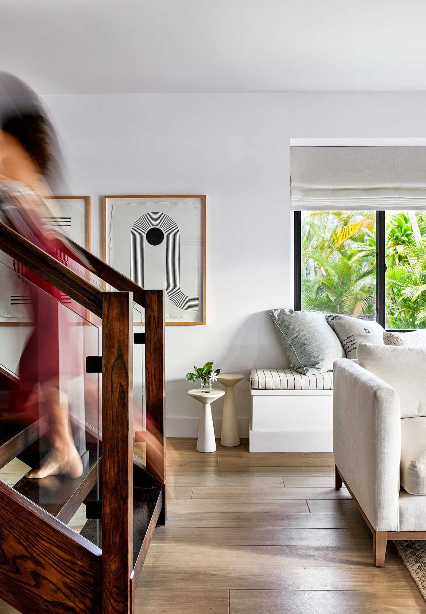 white bungalow living room with exposed stairs