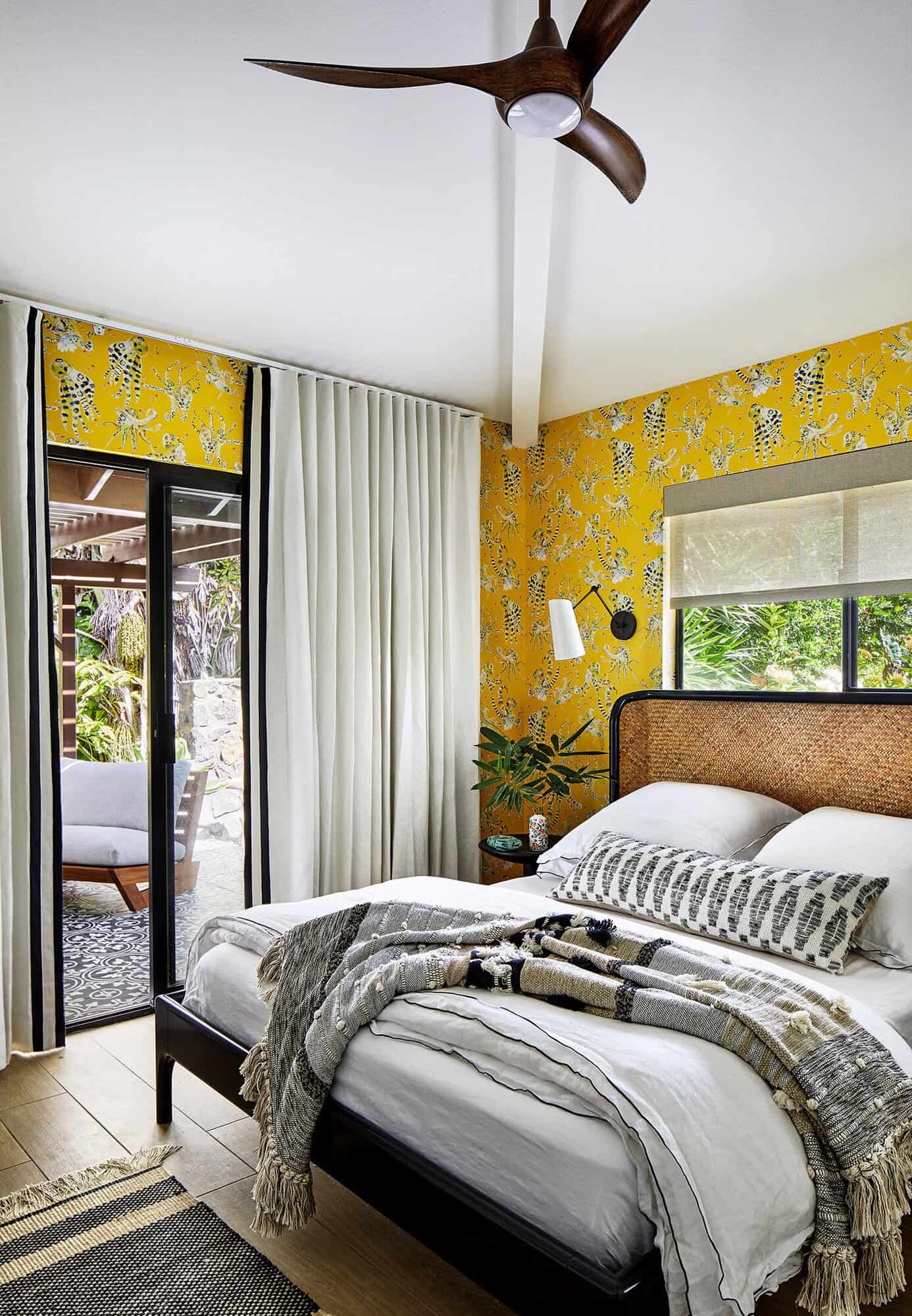 bedroom with yellow wallpaper and patio access