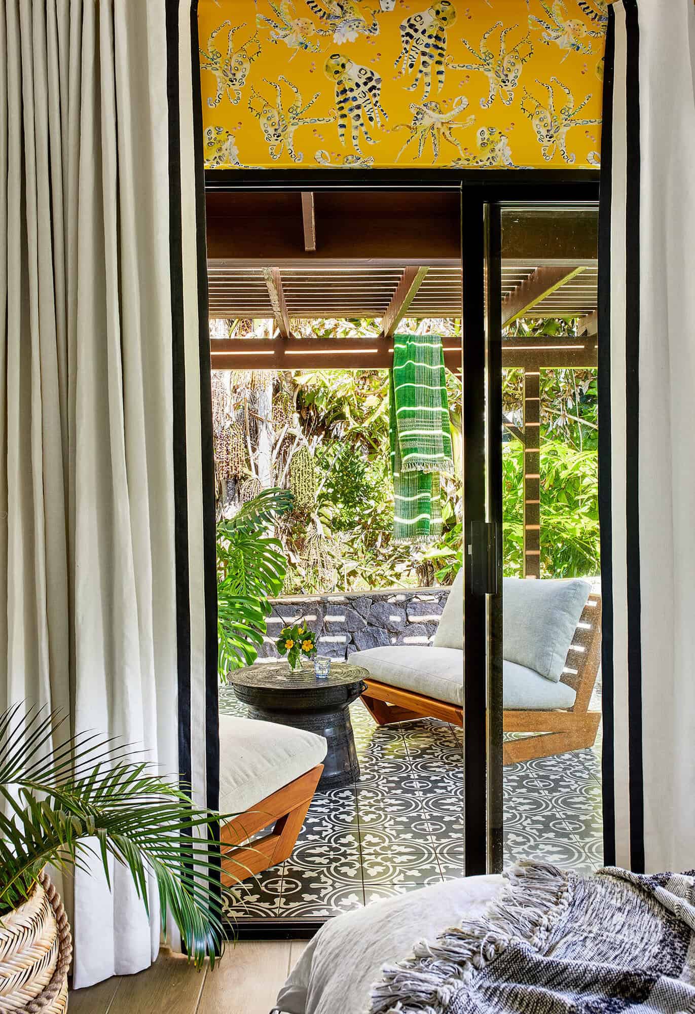 tropical bedroom with a private patio