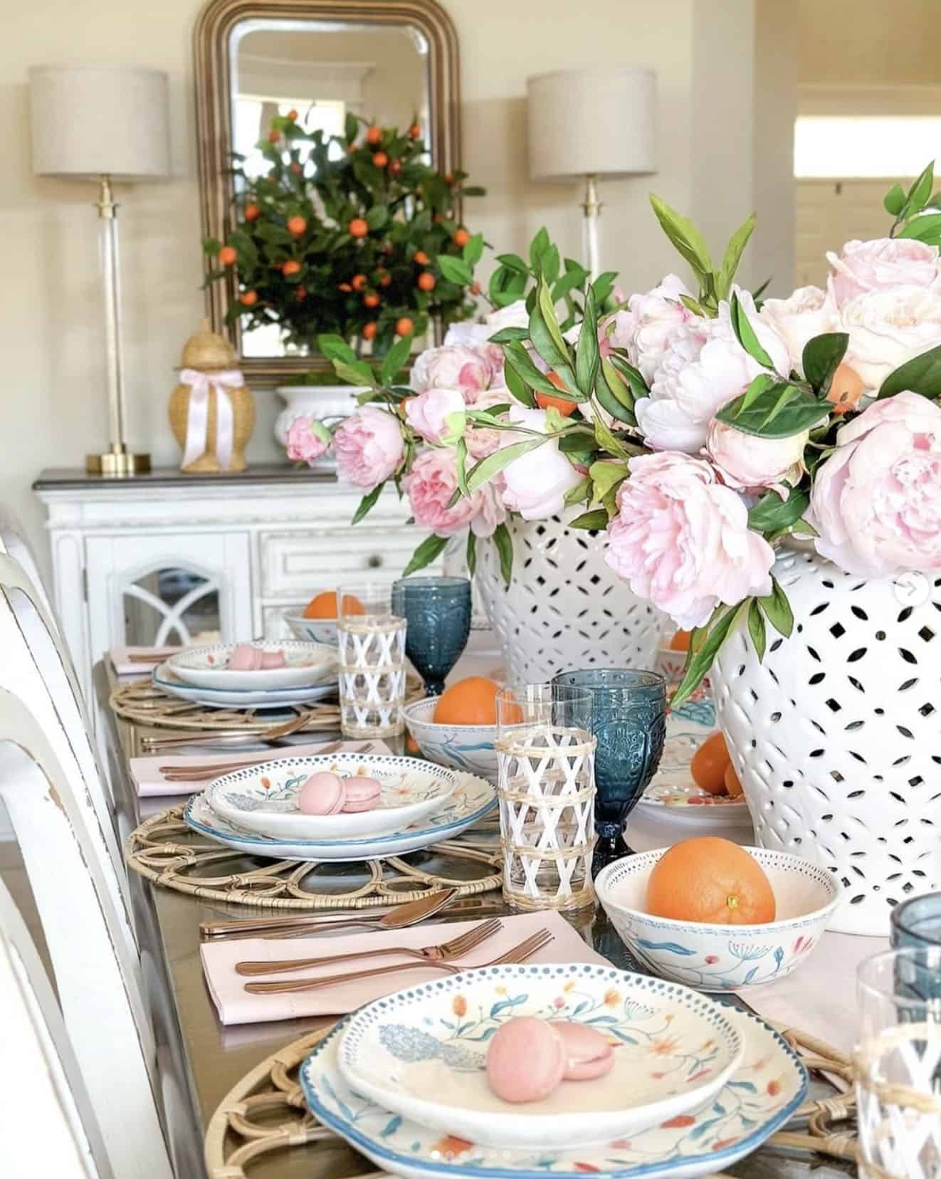 spring decorated dining table with pink flowers in white vases