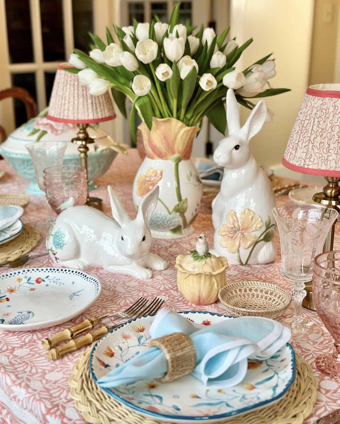 spring table decor with an easter bunny and floral arrangement