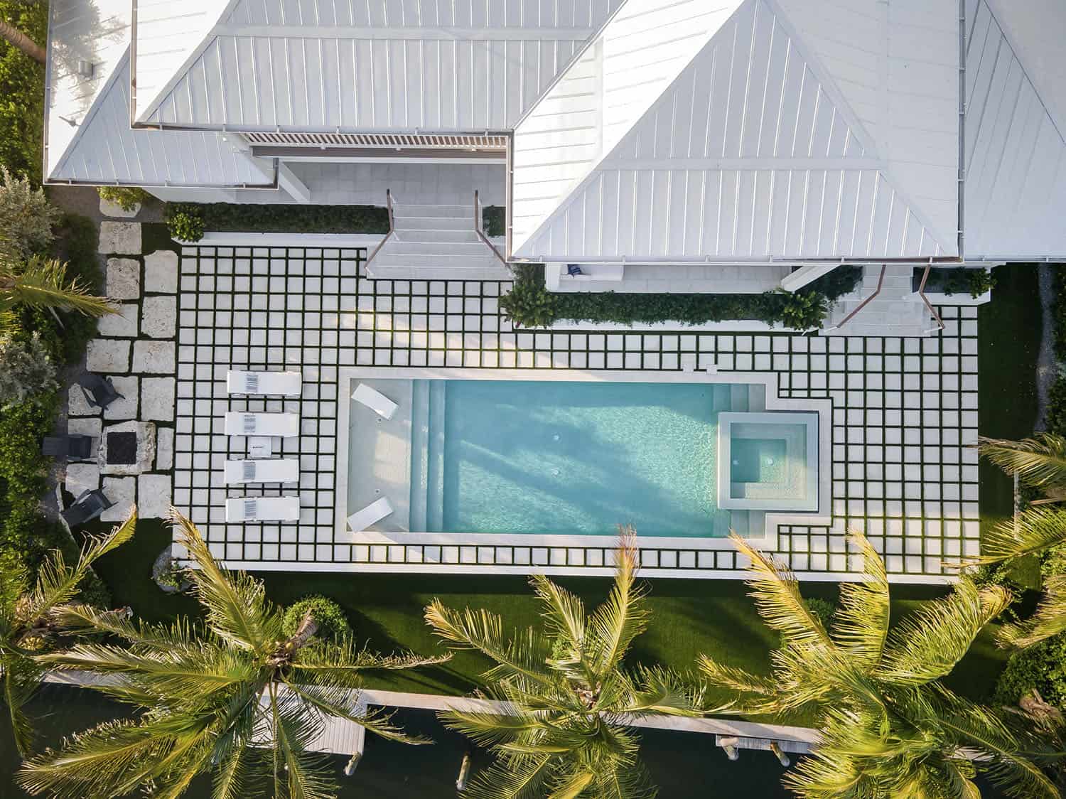 contemporary coastal home exterior with a pool aerial view