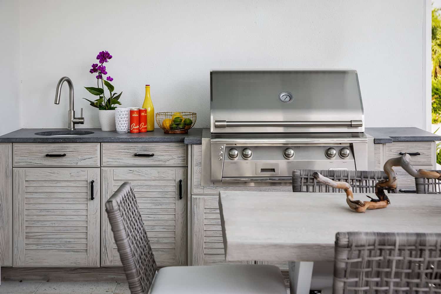 contemporary coastal home patio with an outdoor kitchen