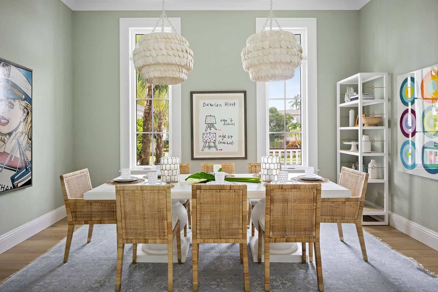 contemporary coastal dining room with large pendant lights