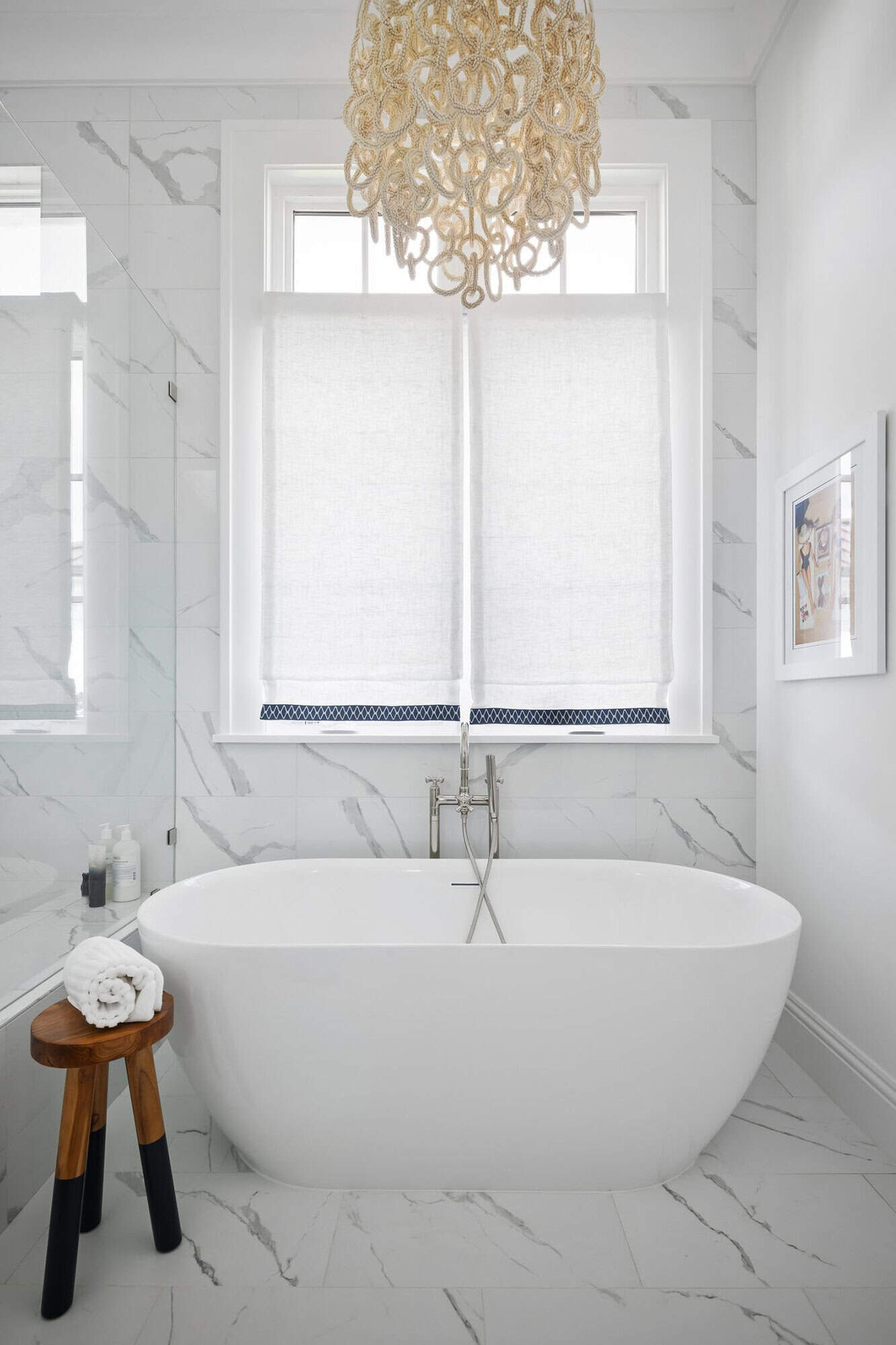 contemporary coastal bathroom with a freestanding tub