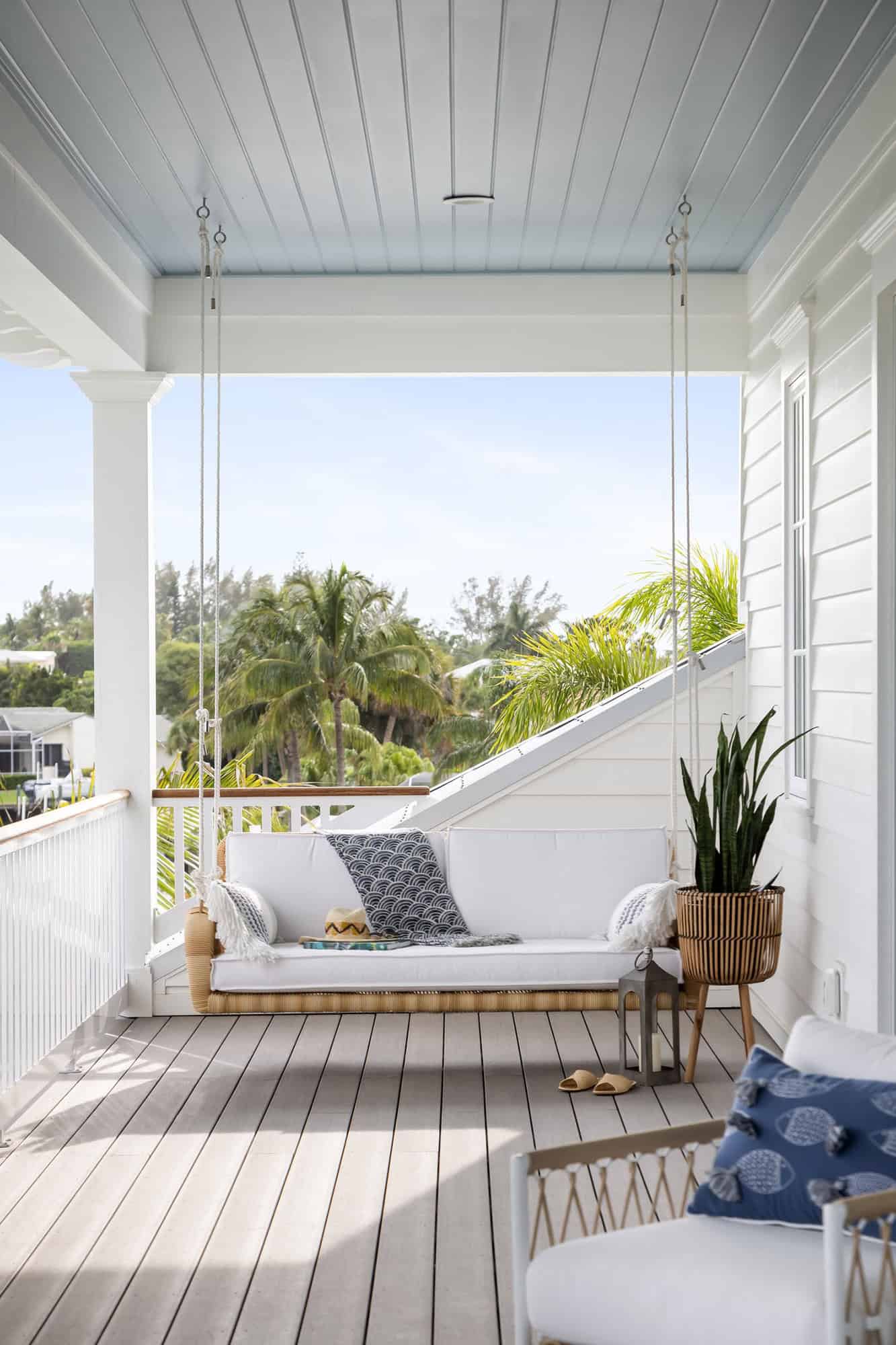 contemporary coastal covered deck with a hanging daybed