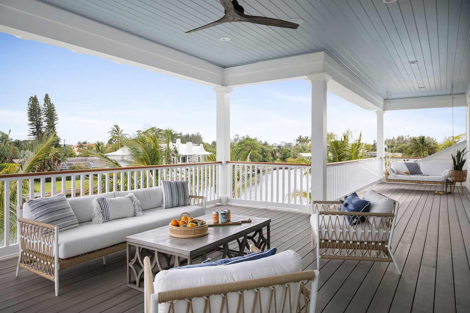 contemporary coastal covered deck with outdoor furniture