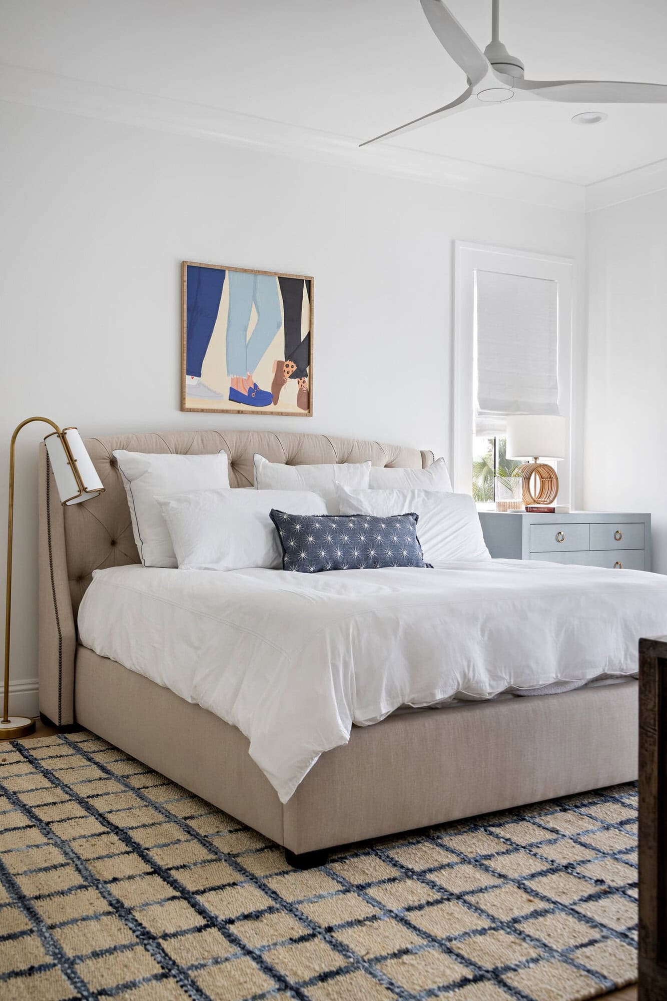 contemporary coastal bedroom with artwork above the headboard