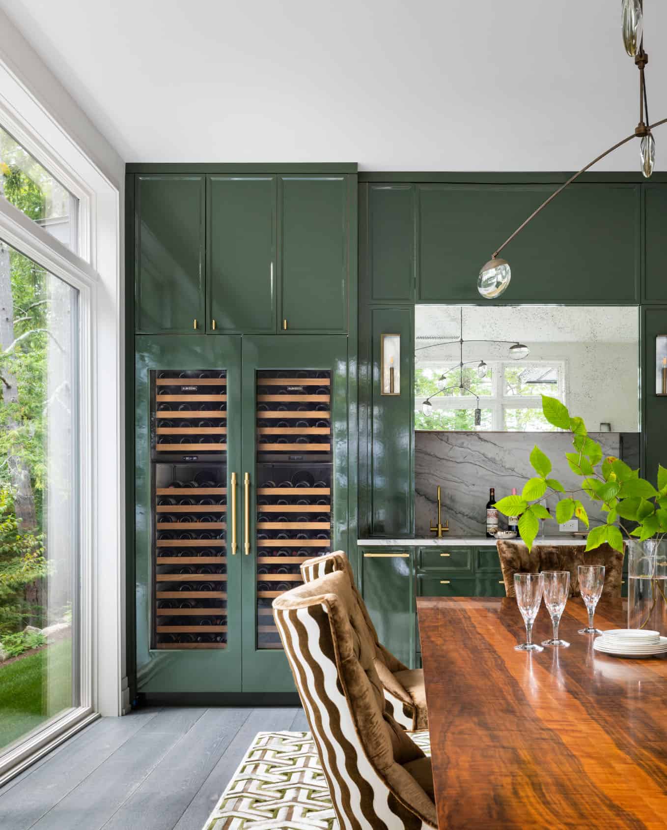 contemporary dining room with green cabinets