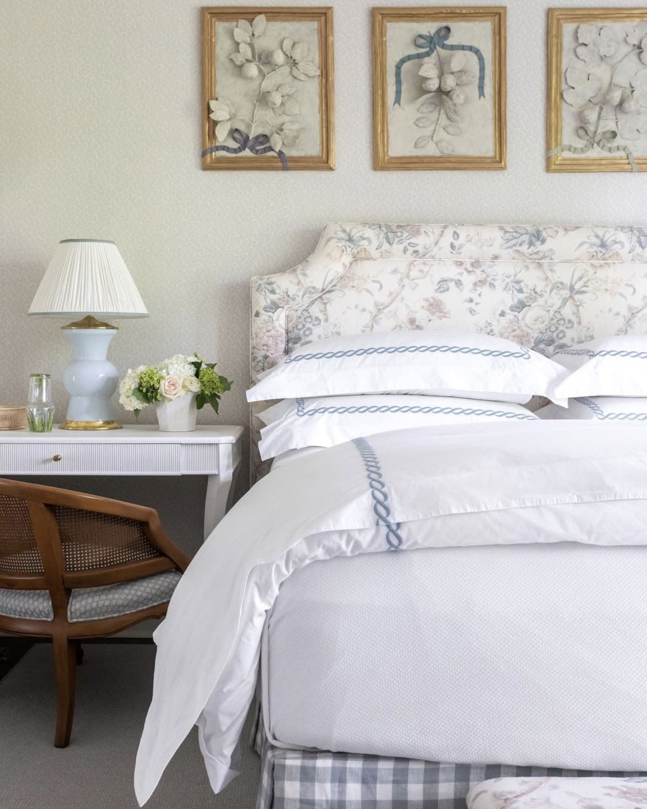 cozy bedroom with spring flowers on the night table