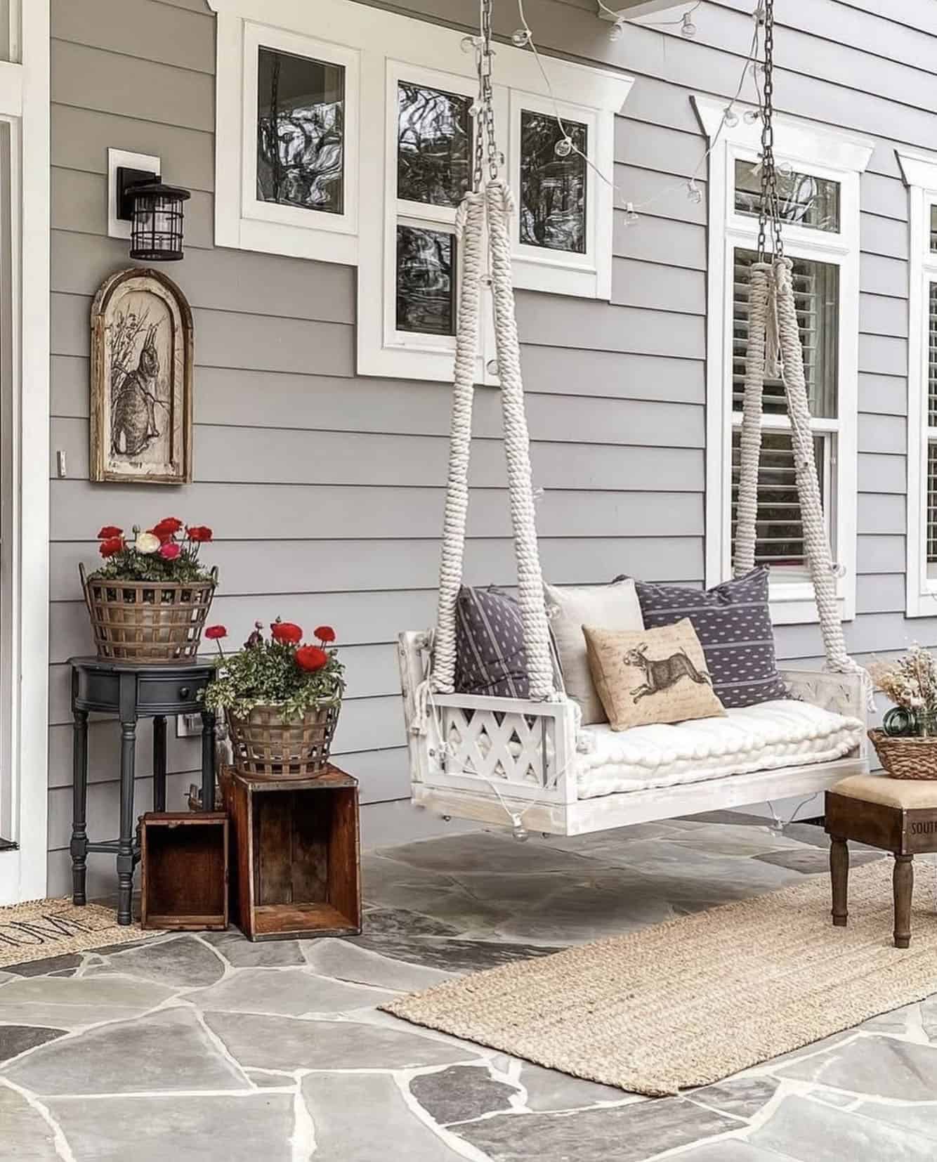 front porch decorated for easter with a hanging daybed