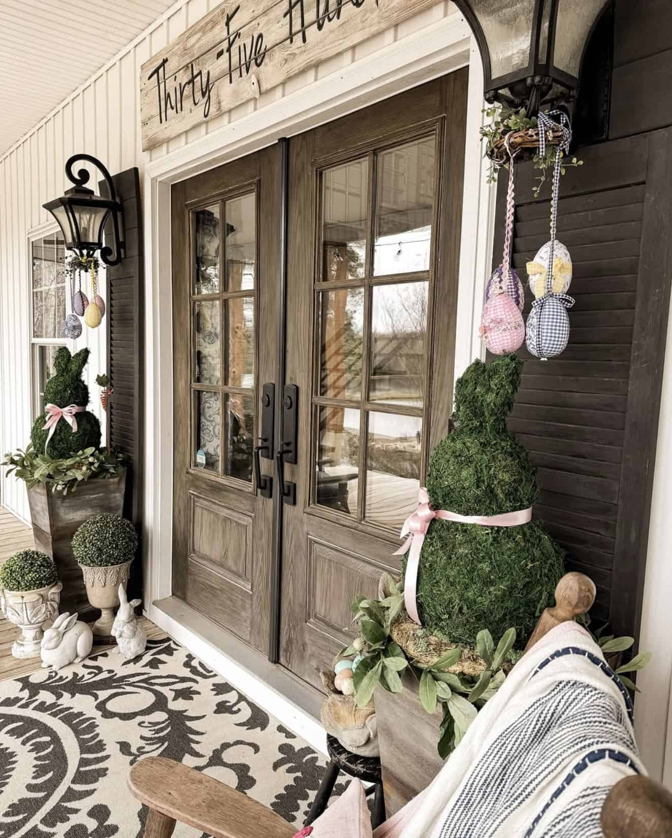 diy dollar tree moss bunnies on the front porch