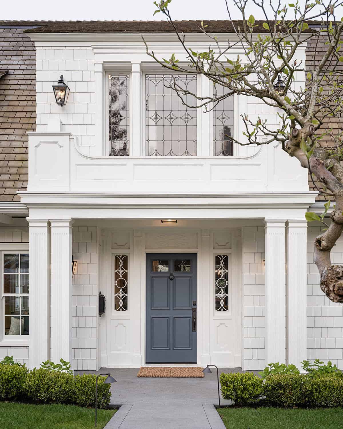 dutch colonial style home exterior with a blue door