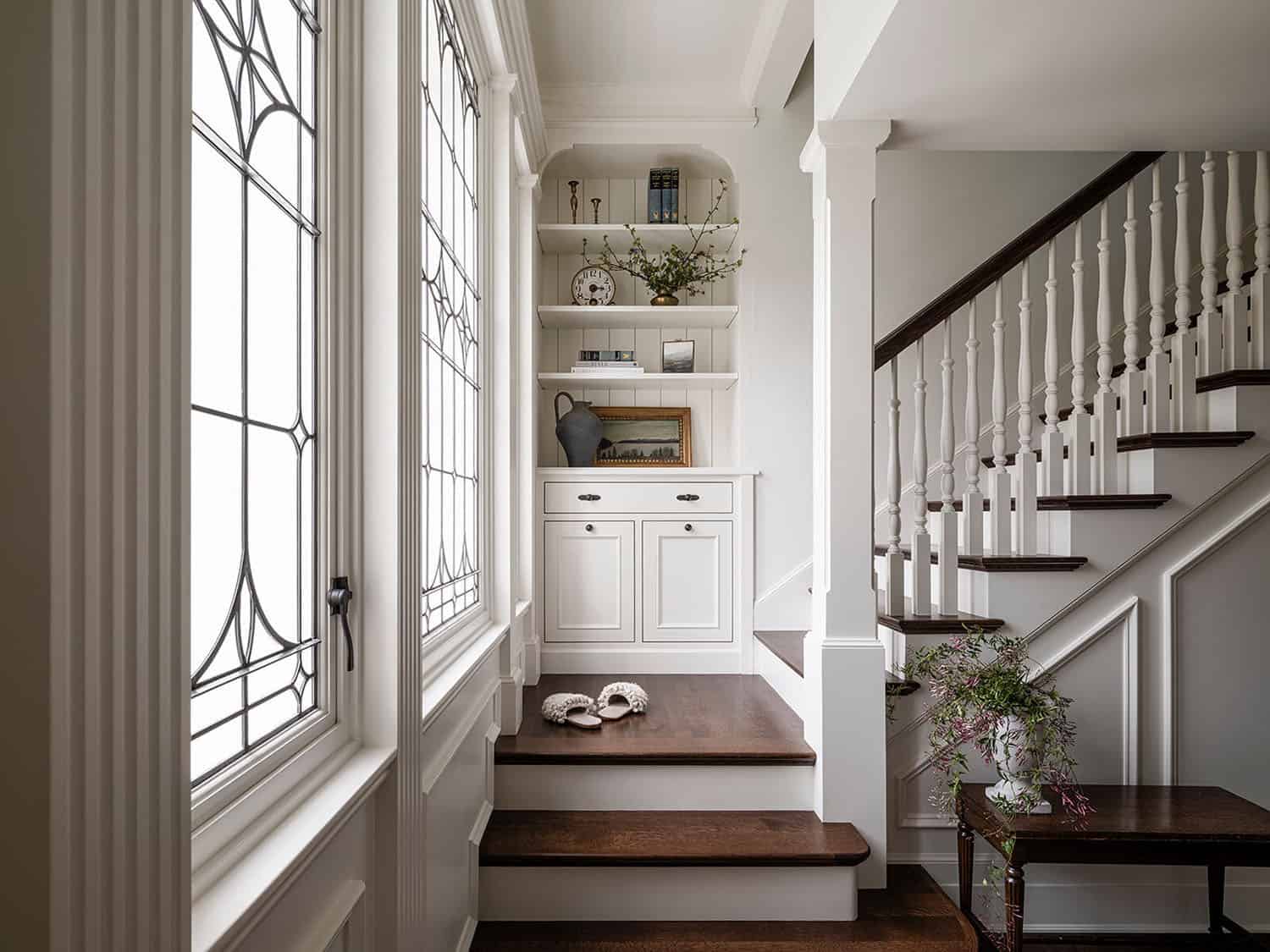 traditional style staircase with a built-in cabinet