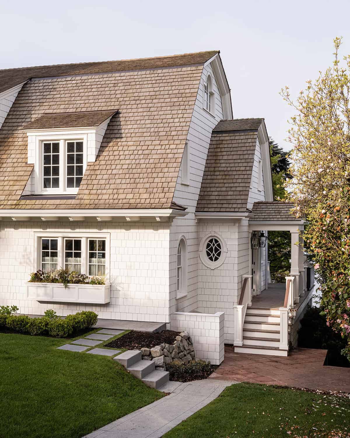 dutch colonial style home exterior with a window box