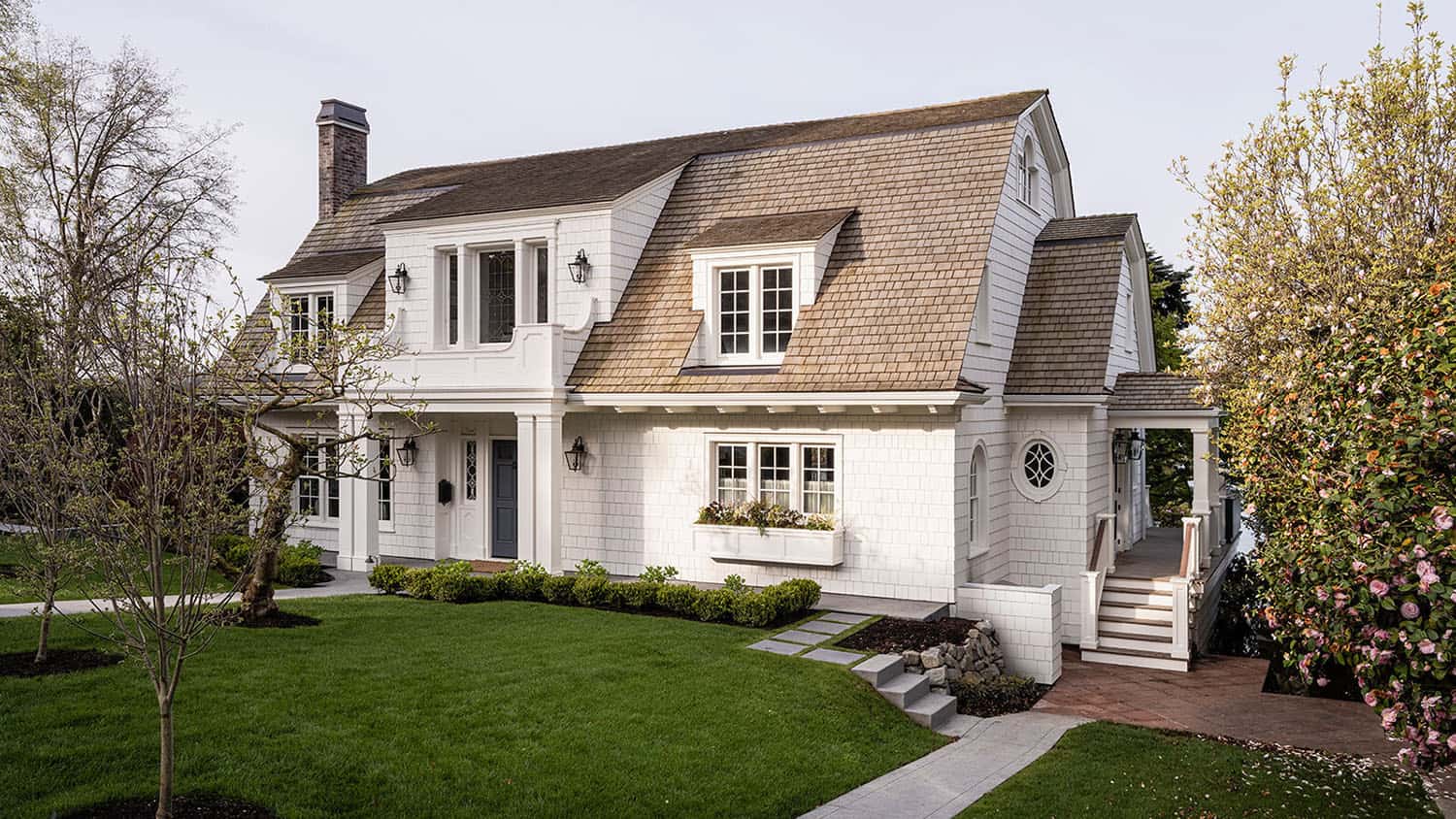 dutch colonial style home exterior with a window box