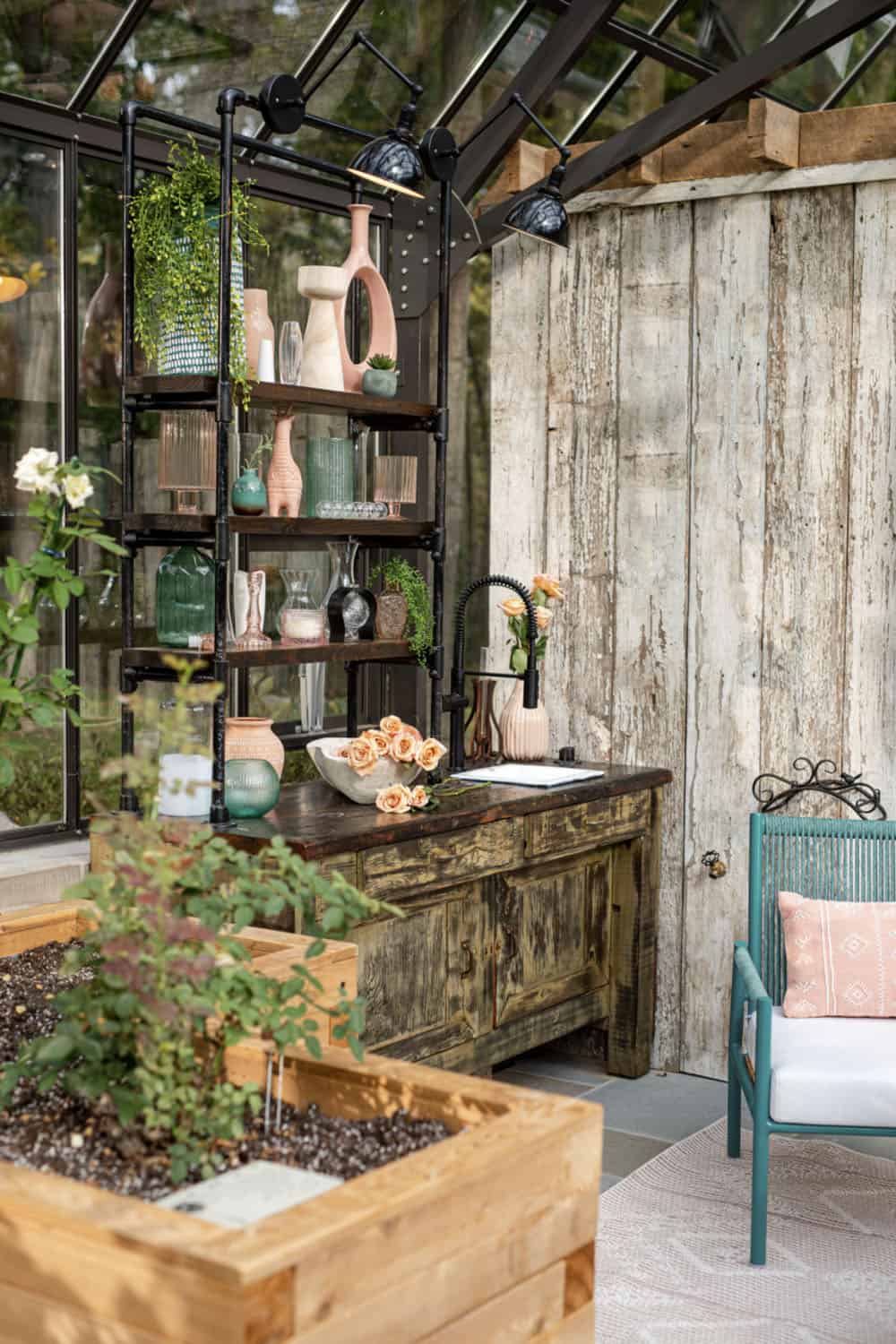 modern glass greenhouse with a historic 100-year-old workbench and cast iron sink