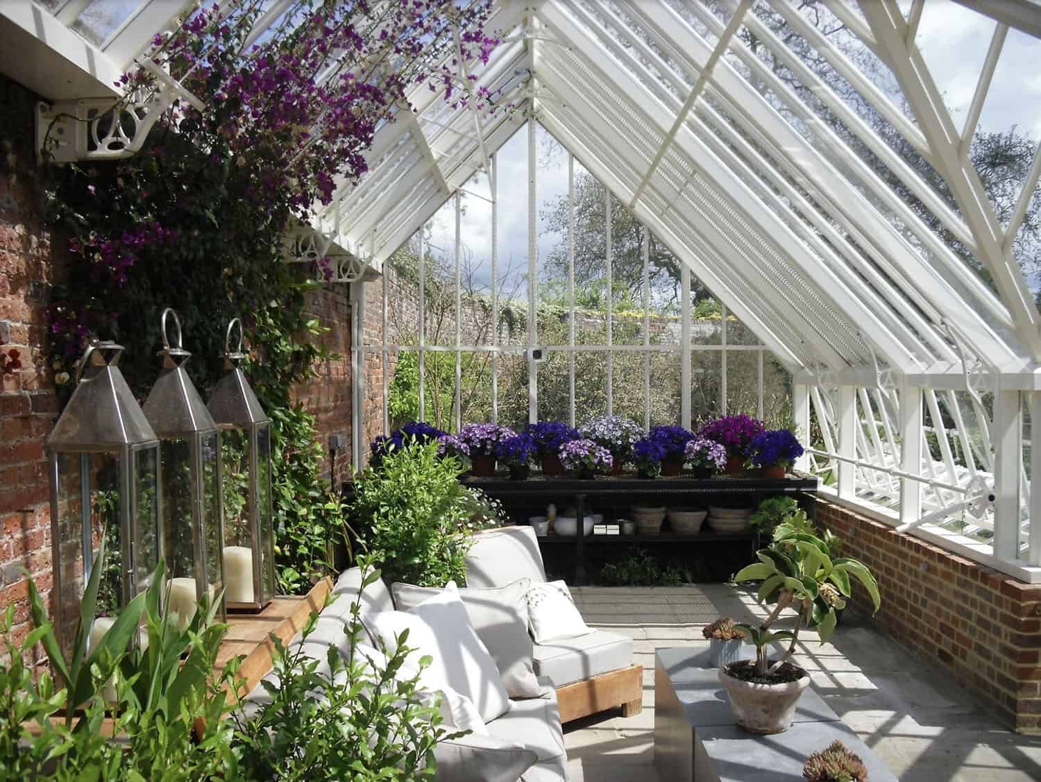 lean-to greenhouse interior with a living area and plants