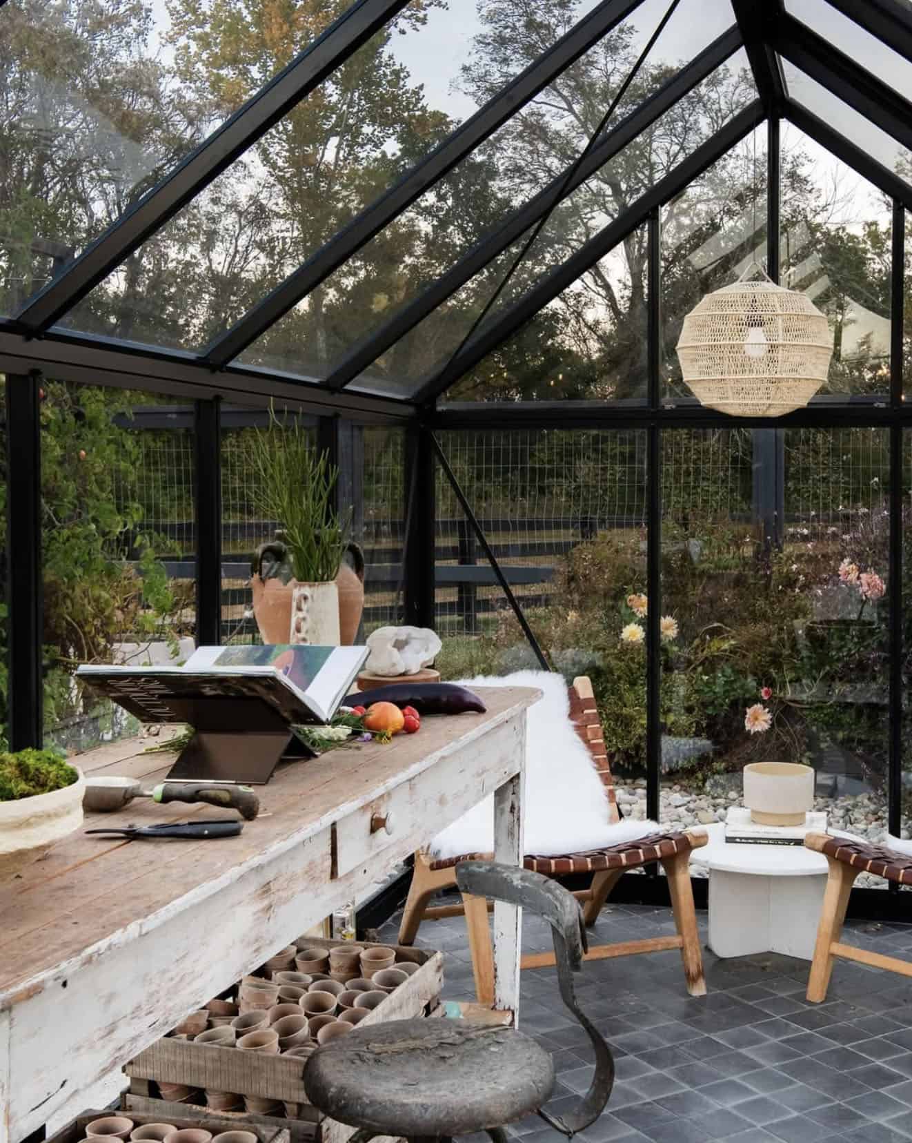 greenhouse interior with a potting table and sitting area