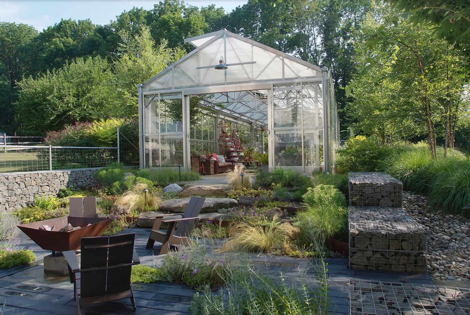 greenhouse exterior with a garden and fire pit