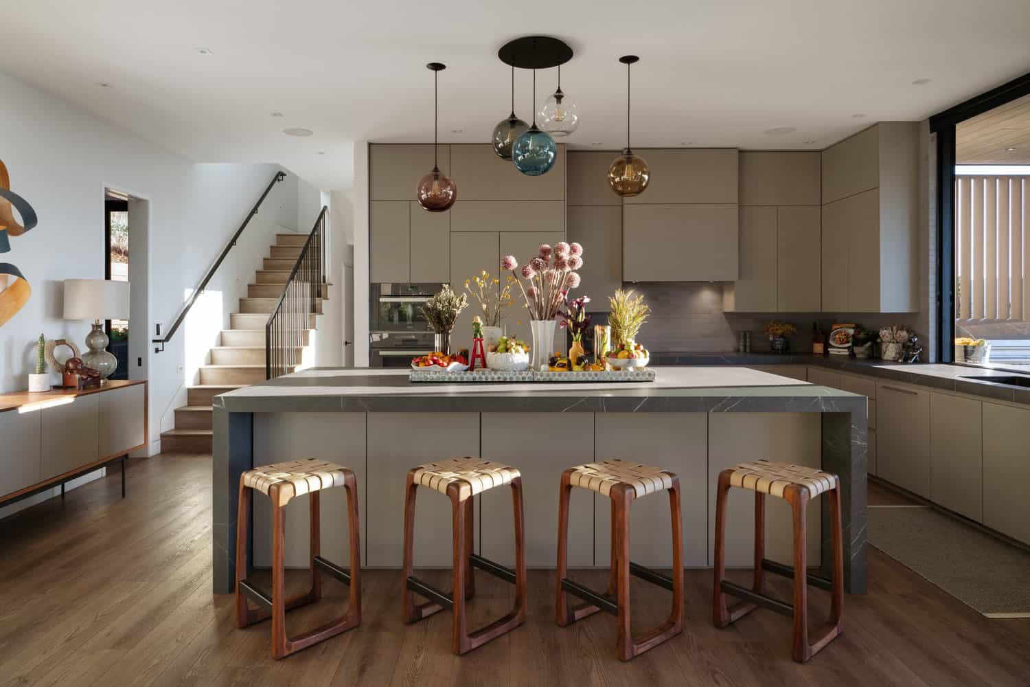 modern kitchen with colorful glass pendant lights