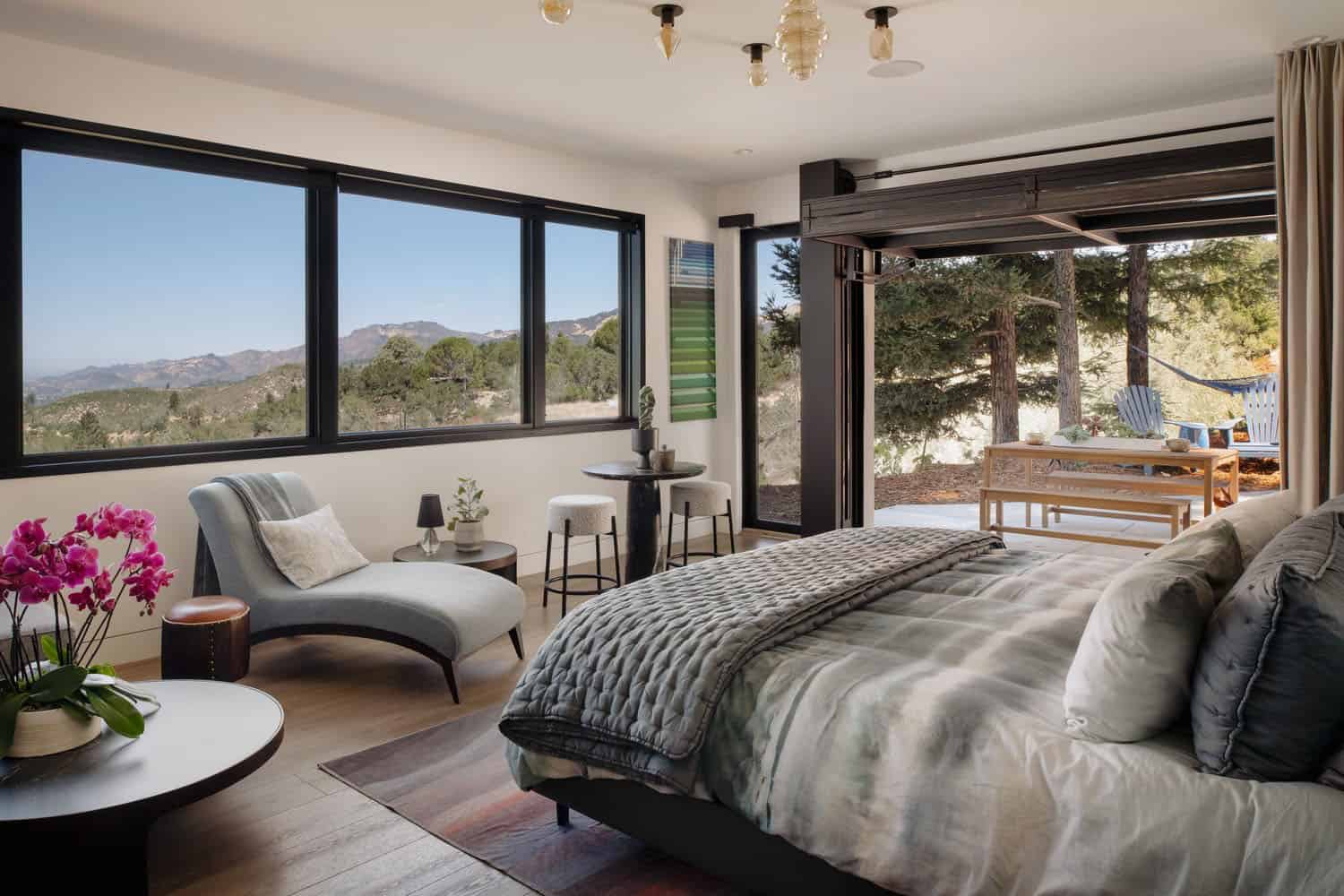 modern bedroom with a roll-up door and private patio