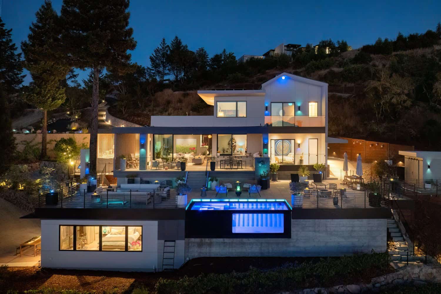 modern ranch house exterior backyard view at dusk