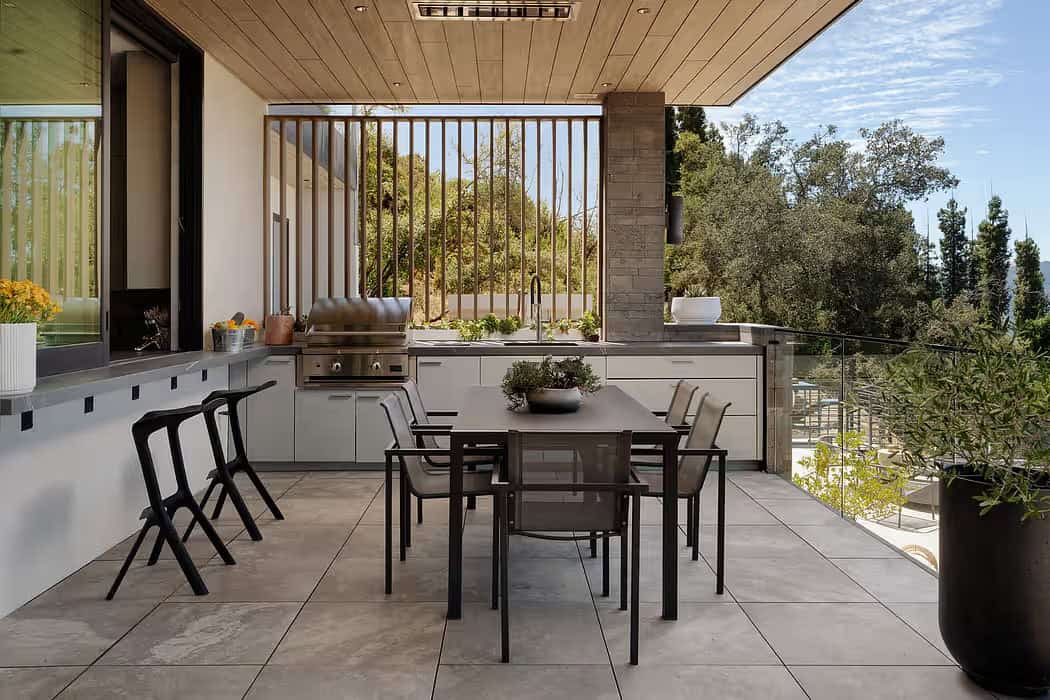 modern covered porch with an outdoor kitchen and alfresco dining