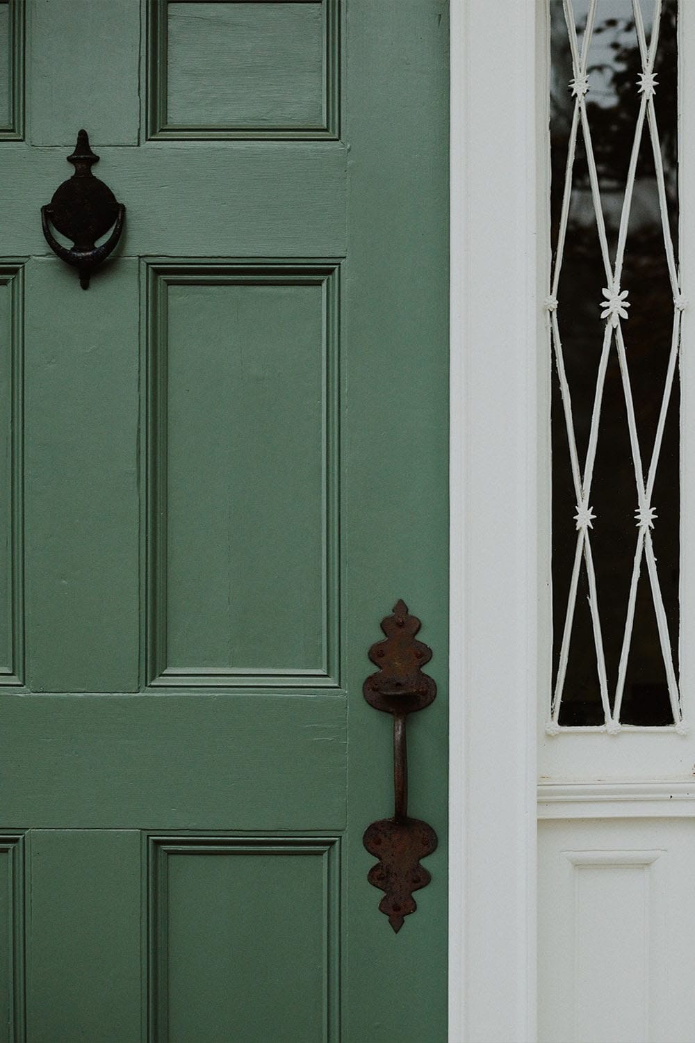 historic farmhouse exterior with a green door
