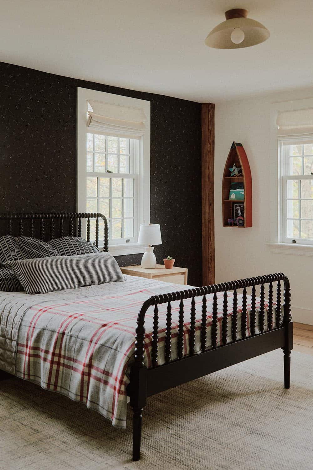 farmhouse style bedroom with a dark accent wall